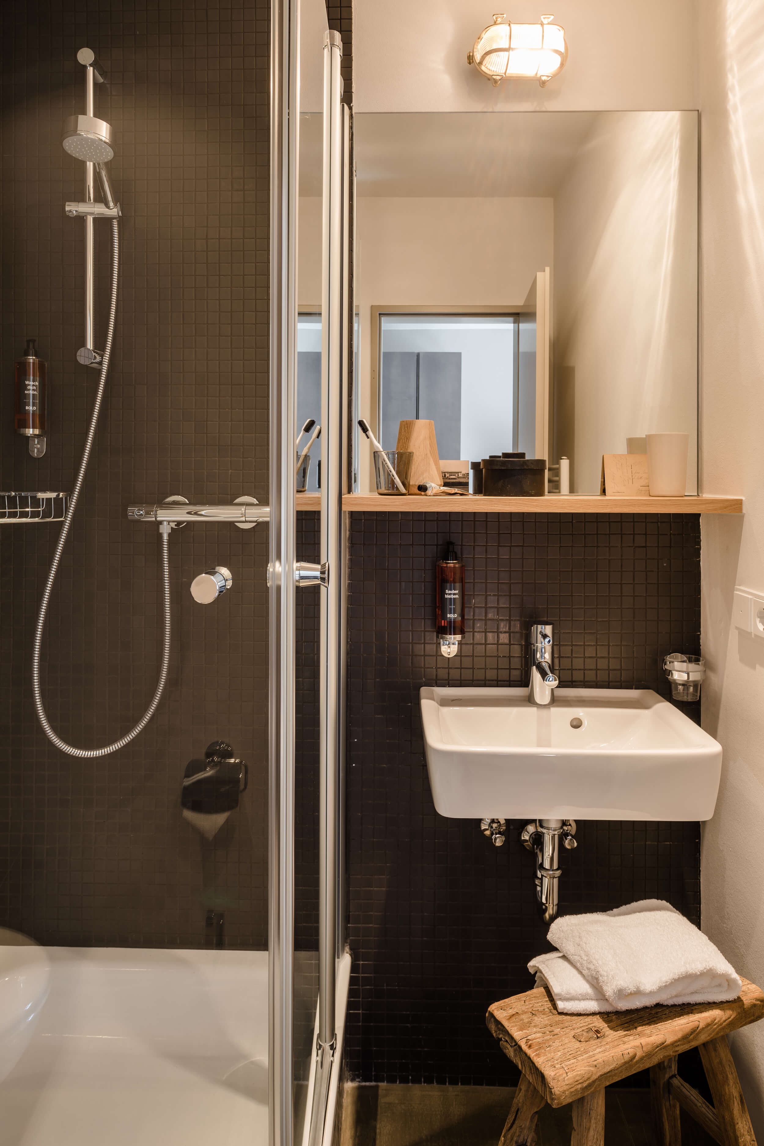A modern bathroom. In the cut a shower cubicle and washbasin with accessories.