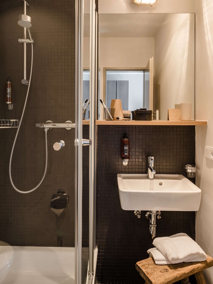 A modern bathroom. In the cut a shower cubicle and washbasin with accessories.